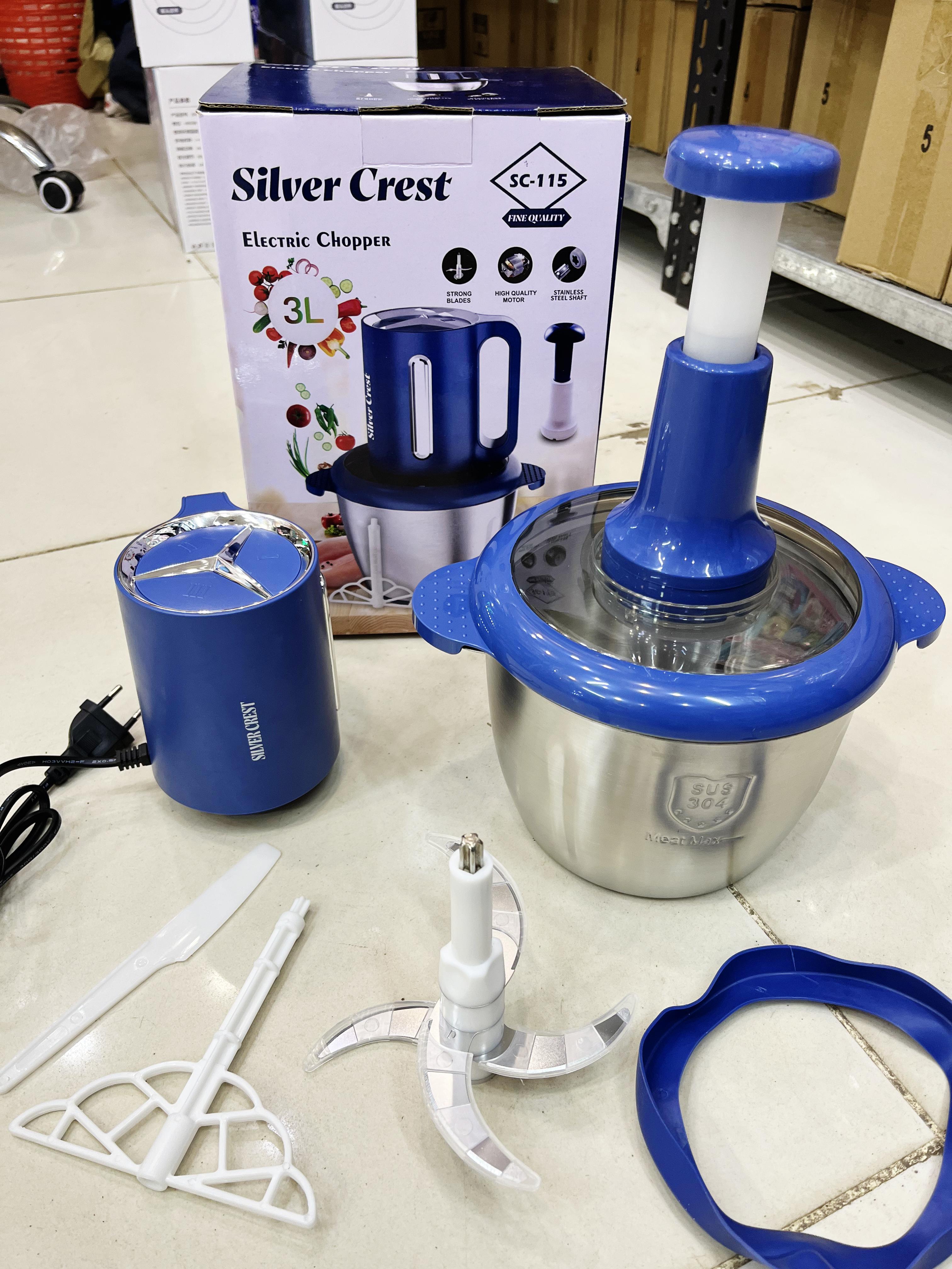 Silver Crest electric chopper with parts on a tiled floor