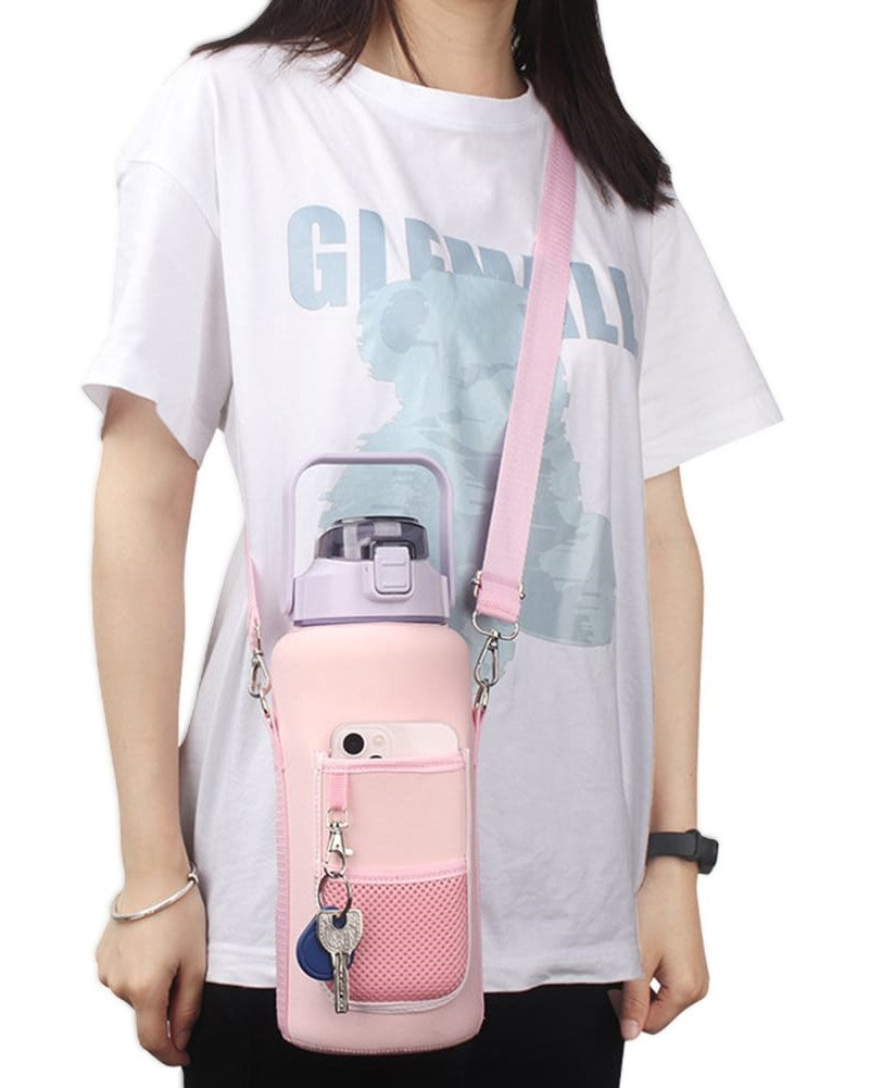 Person holding a pink water bottle holder with a strap, wearing a white t-shirt with text.
