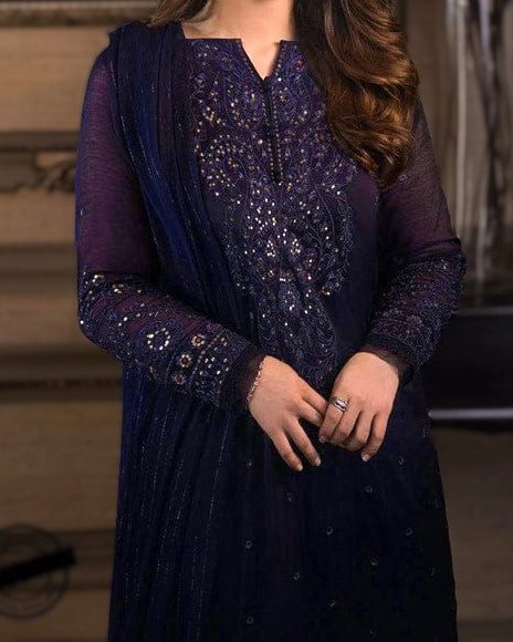 Navy blue embroidered dress with matching dupatta on a blurred background