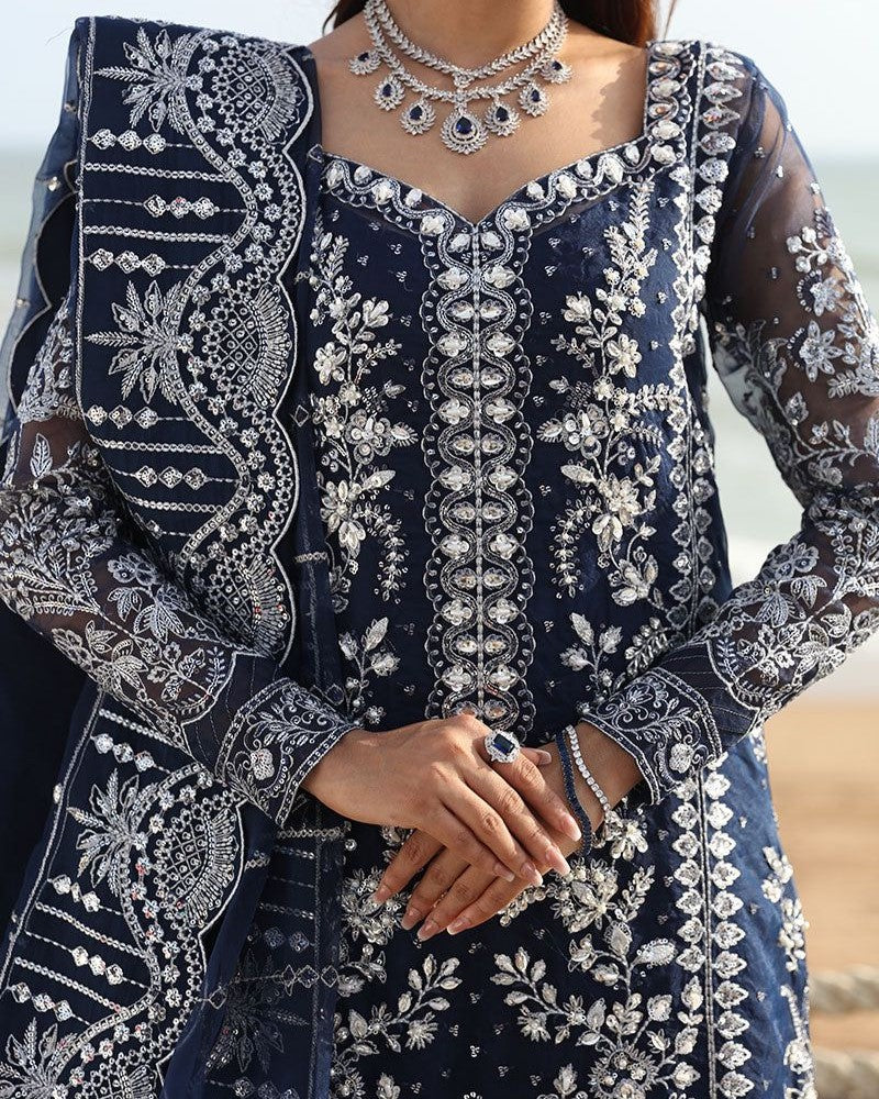 Front view of elegant net suit with embroidered dupatta
Close-up of adda, thread, and sequence embroidery on net fabric