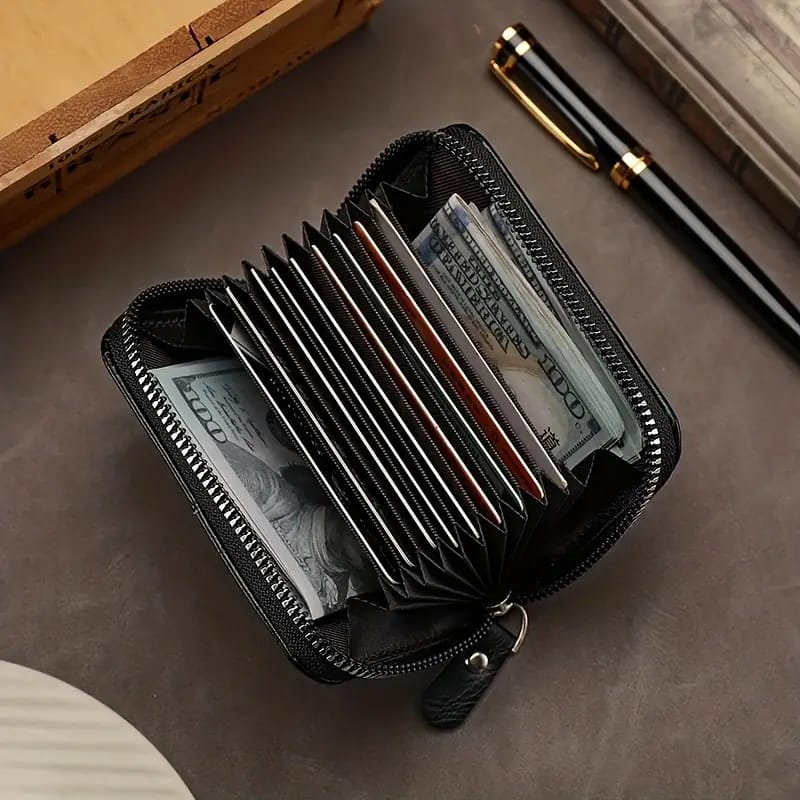 Elegant black wallet with zipper and matching cardholder placed on a table
Spacious brown wallet with top zip open showing inner compartments