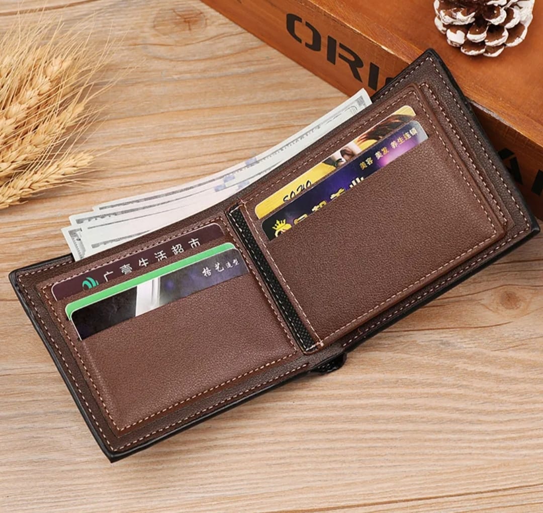 Brown leather wallet with cards and money on a wooden surface