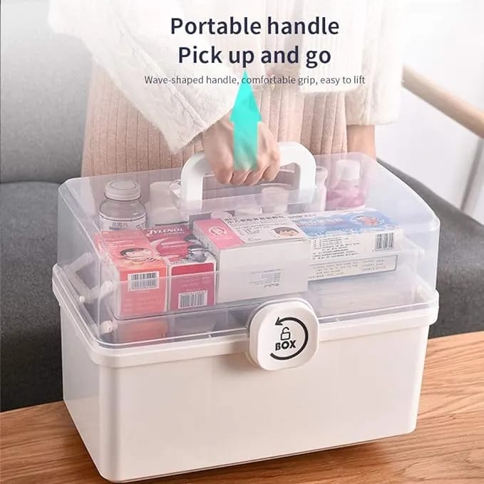 Portable storage box with a handle, containing various items on a wooden surface.