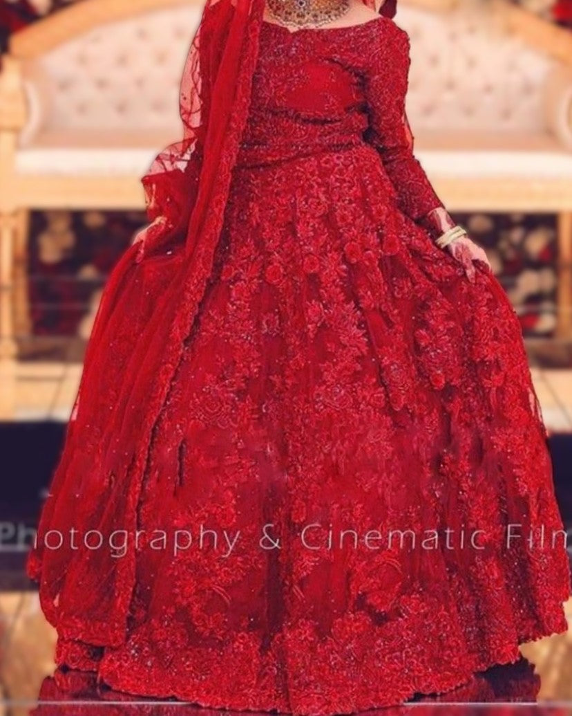 Red lace dress with matching dupatta on a decorative chair