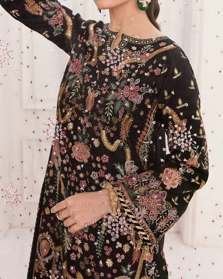 Black embroidered traditional outfit with floral patterns on a white background