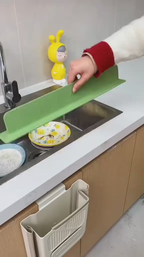 Silicone splash guard fitted around kitchen sink edge to stop water spills.
Close-up of flexible silicone splash guard being installed on a kitchen countertop.