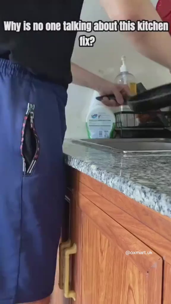 Person stretching the silicone splash guard showing its flexibility in a clean kitchen.
Water flowing inside the sink with splash guard preventing overflow onto the countertop.